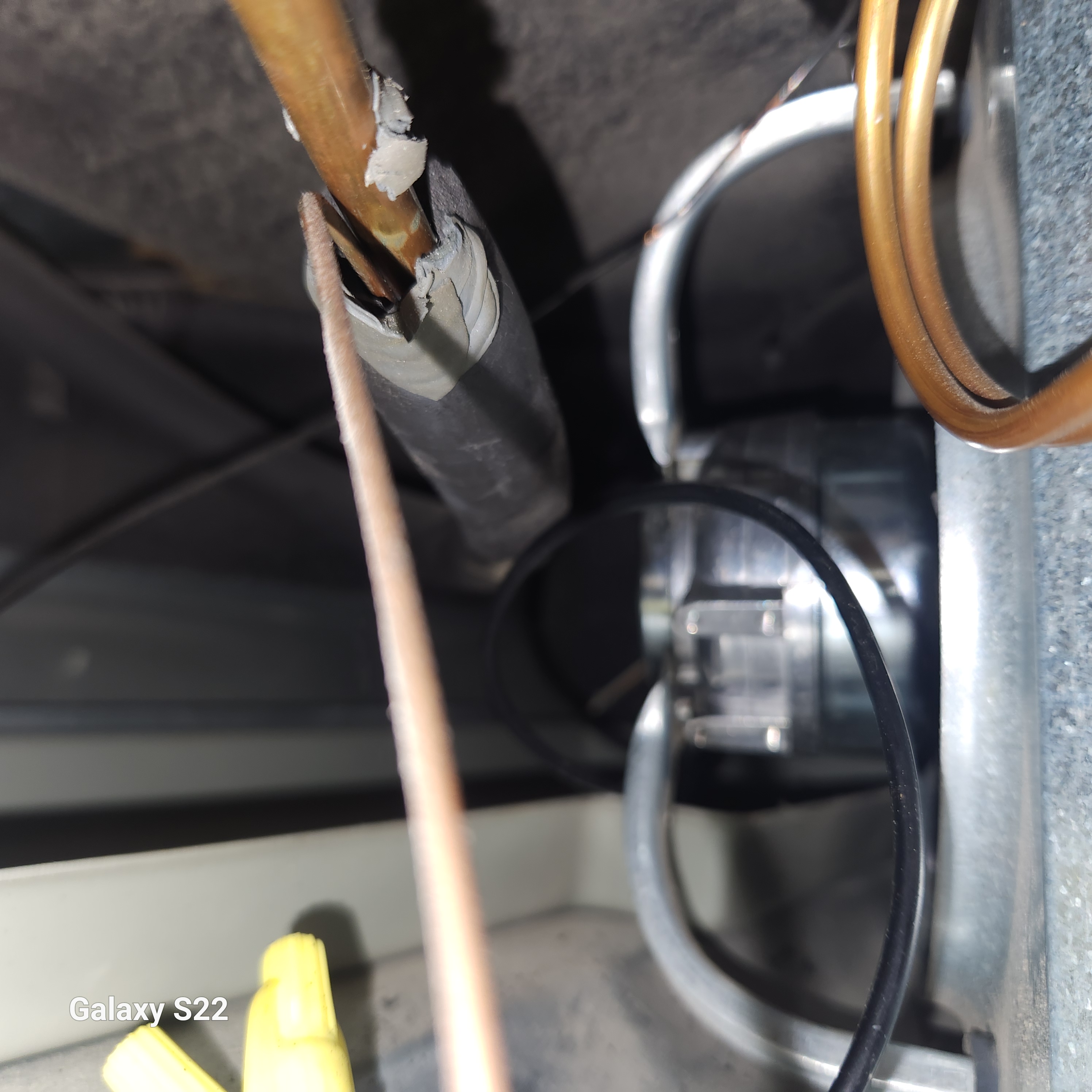 Machine compartment of a Sub-Zero 736 built-in refrigerator showing the condenser coil, refrigerant lines and condenser fan